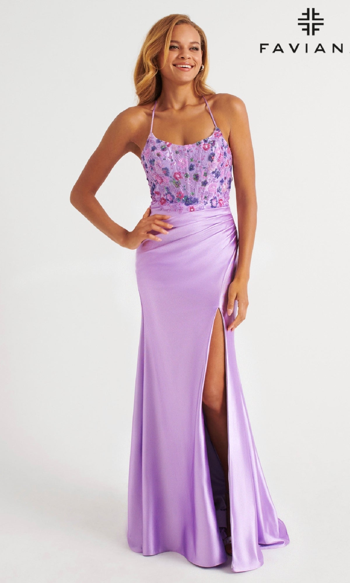A woman wears the Faviana 11252 long lilac stretch satin bodycon prom dress featuring floral beaded applique bodice, spaghetti straps, lace-up open back, and thigh-high slit; “FAVIAN” logo appears top right.